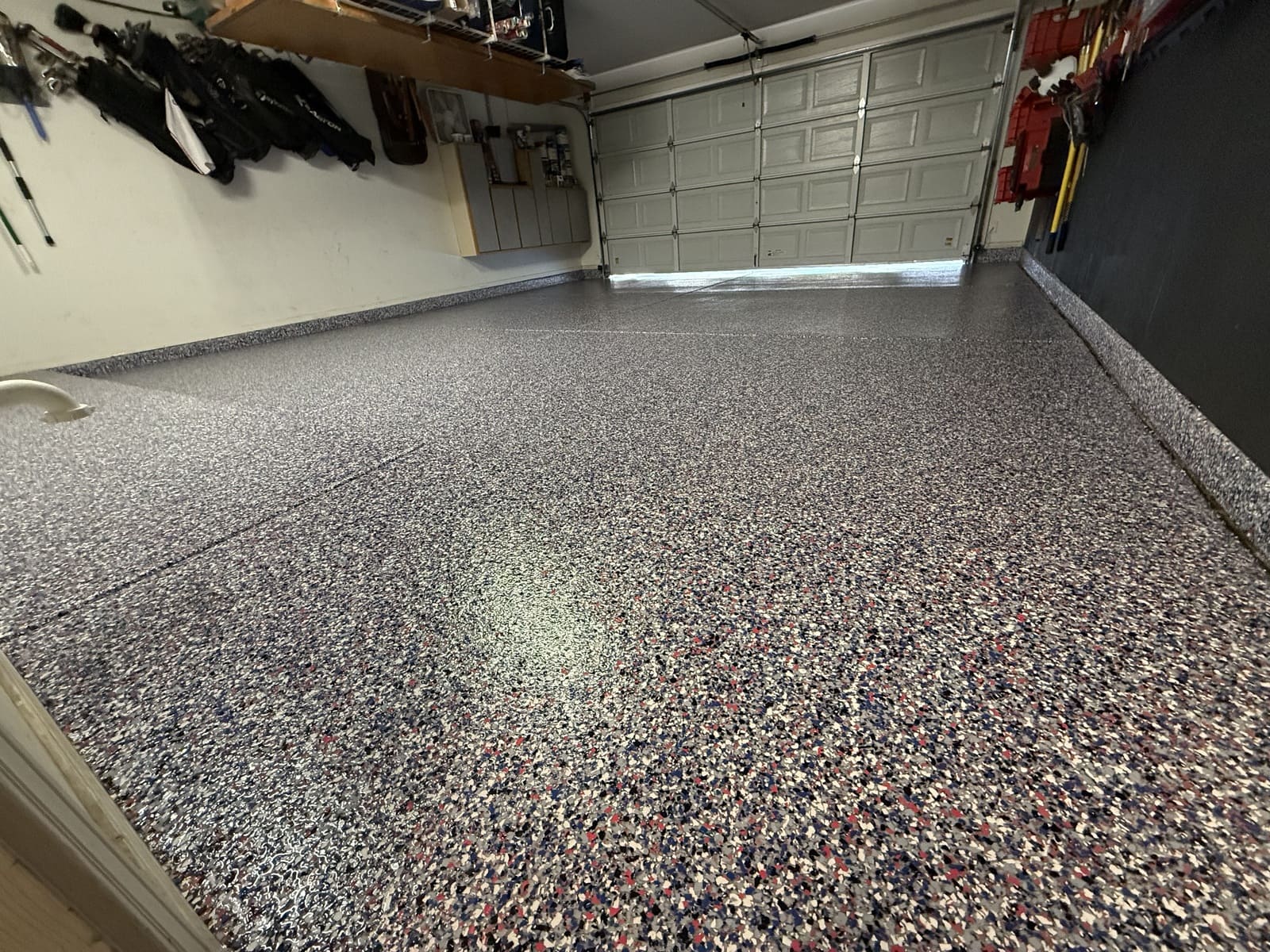 Decorative epoxy poly chip garage floor with a textured, durable, easy-to-clean finish
