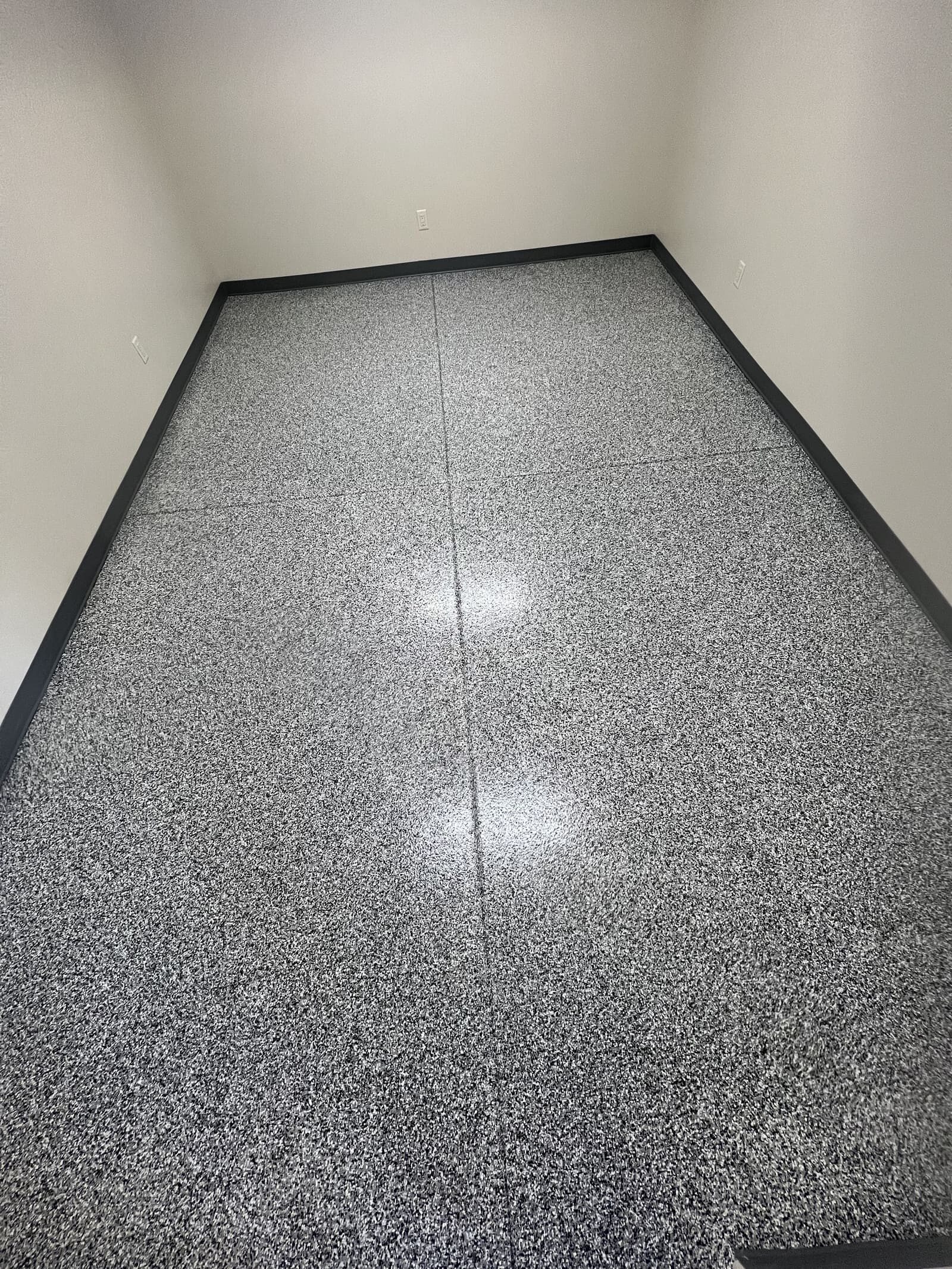 Gray epoxy flake garage floor coating with a seamless, high-gloss, UV-resistant finish for durable residential and commercial flooring.