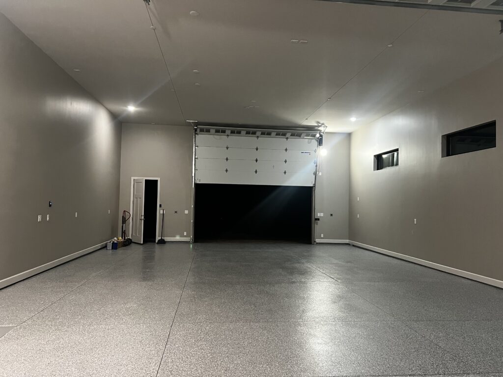 Garage in Flagstaff, AZ with a professionally installed gray flake epoxy garage floor coating